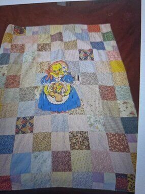 VIINTAGE HANDMADE PATCHWORK BLANKET WITH A CENTERAL HOLLIE HOBBY CHARACTER